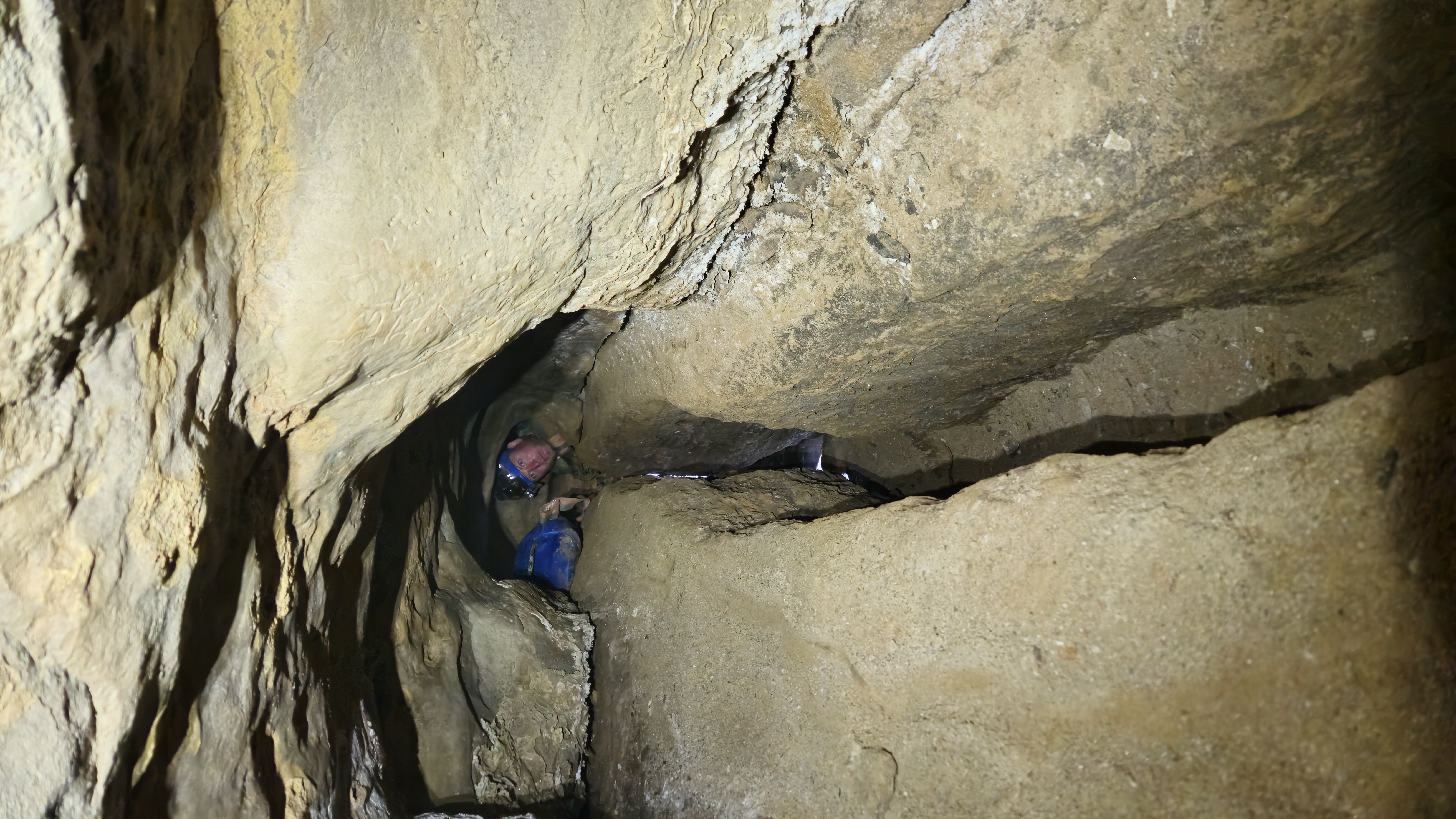 Underground caving scene with layered rock walls